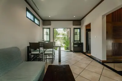 a living room with a couch and a table at Rose Pool Villa The perfect private oasis in Rawai Beach