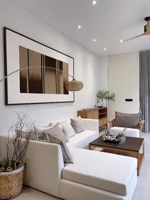 a living room with a white couch and a table at Tree O'clock Pool Villa - Phuket in Thalang