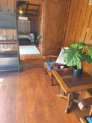 a living room with a table and a couch at Niyang Siam House in Nai Yang Beach