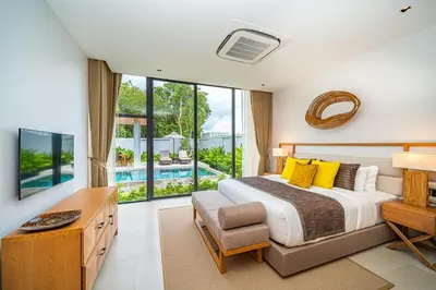 a bedroom with a bed and a large window at Botanica Foresta - 4 Bedroom Spacious Luxury Pool Villa in Layan in Ban Phru Champa