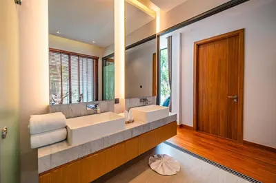 a bathroom with two sinks and a large mirror at Botanica Foresta - 4 Bedroom Spacious Luxury Pool Villa in Layan in Ban Phru Champa
