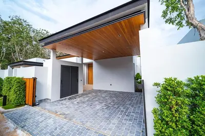 a white house with a wooden roof at Botanica Foresta - 4 Bedroom Spacious Luxury Pool Villa in Layan in Ban Phru Champa