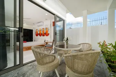 a room with a table and chairs and a bedroom at Spacious 4BR Private Pool Villa Luna in Rawai Beach
