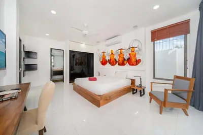 a bedroom with a bed and a desk and chair at Spacious 4BR Private Pool Villa Luna in Rawai Beach