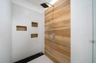 a bathroom with a shower with a wooden wall at Spacious 4BR Private Pool Villa Luna in Rawai Beach