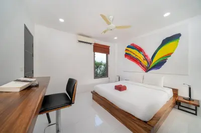 a bedroom with a bed and a desk with a computer at Spacious 4BR Private Pool Villa Luna in Rawai Beach