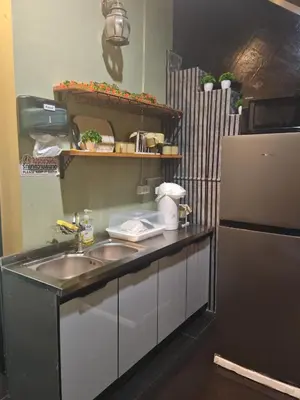 a kitchen with a sink and a refrigerator at TJ Patong HOSTEL in Patong Beach