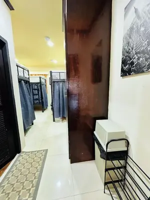 a dressing room with a bench and a closet at TJ Patong HOSTEL in Patong Beach
