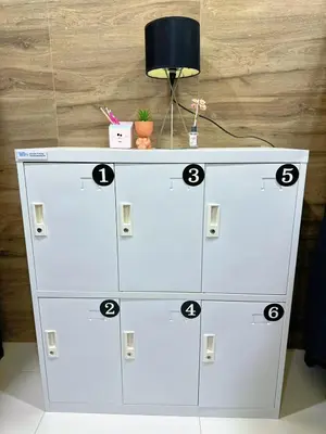 a white dresser with numbers on top of it at TJ Patong HOSTEL in Patong Beach