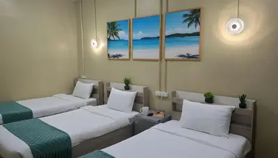 three beds in a room with a view of the beach at I Talay phuket in Karon Beach