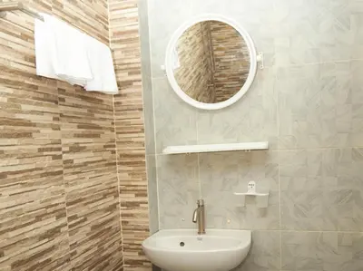 a bathroom with a sink and a mirror at I Talay phuket in Karon Beach
