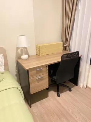 a desk with a lamp and a chair in a bedroom at Dcondo - Kathu, Phuket in Kathu