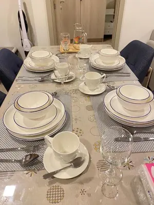 a table with plates and cups and spoons on it at Dcondo - Kathu, Phuket in Kathu