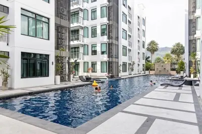 a swimming pool in the middle of a building at Excellent apartment on Kamala in Kamala Beach