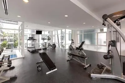 a gym with treadmills and machines in a building at Excellent apartment on Kamala in Kamala Beach