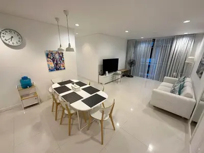 a dining room and living room with a table and chairs at Excellent apartment on Kamala in Kamala Beach