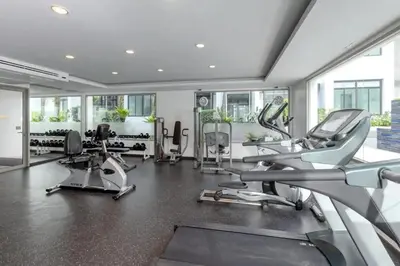 a gym with several cardio machines in a room at Excellent apartment on Kamala in Kamala Beach