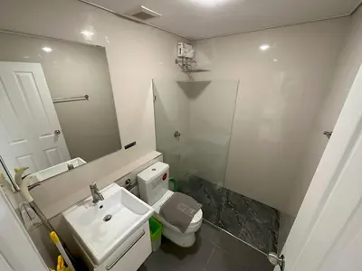a bathroom with a sink and a toilet and a mirror at Excellent apartment on Kamala in Kamala Beach