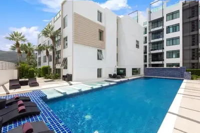 a swimming pool in front of a building at Excellent apartment on Kamala in Kamala Beach