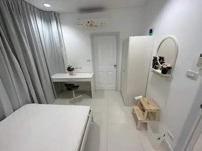 a small white room with a desk and a refrigerator at Excellent apartment on Kamala in Kamala Beach