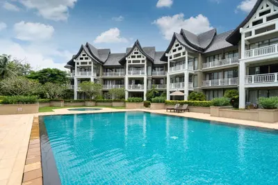 a large apartment building with a large swimming pool at Allamanda Premium Apartments Laguna Phuket in Laguna Phuket