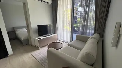 a living room with a couch and a television at Sky Park Laguna Phuket in Laguna Phuket