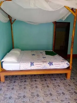 a bed with a canopy in a room at Phukhao thong in Ban Bang Chak