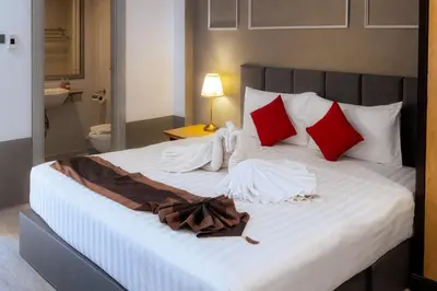 a bedroom with a bed with red and white pillows at Stay at Bedroom in Patong Beach