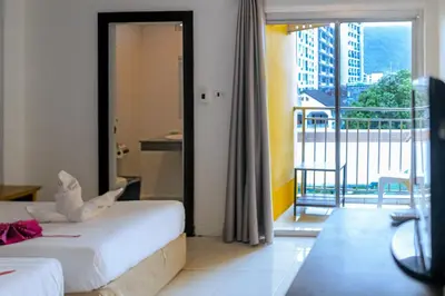 a hotel room with two beds and a balcony at Stay at Bedroom in Patong Beach