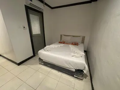 a bedroom with a bed in a white room at Stay at Bedroom in Patong Beach