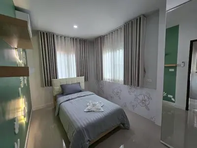 a bedroom with a bed with a towel on it at MB Home in Ban Bang Khu
