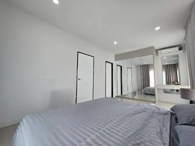 a white bedroom with a large bed and mirrors at MB Home in Ban Bang Khu