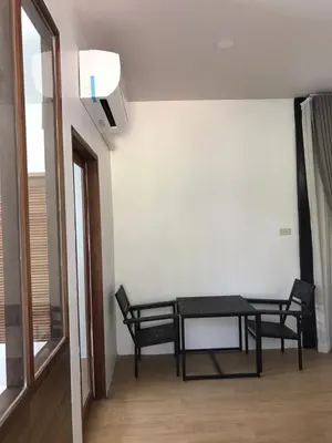 a dining room with a table and two chairs at maksaihomestay in Ban Lo Pa Ret