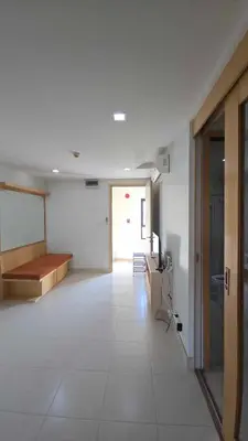 a room with a hallway with a table and a couch at The Feeltrue phuket ck in Ban Klang