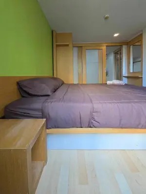 a bedroom with a large bed with purple sheets at The Feeltrue phuket ck in Ban Klang