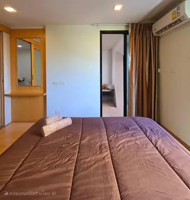 a large bed with a brown blanket on it at The Feeltrue phuket ck in Ban Klang