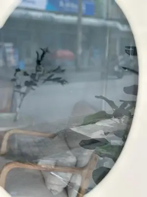 a reflection of a chair in a window at Lfour phuket in Phuket Town