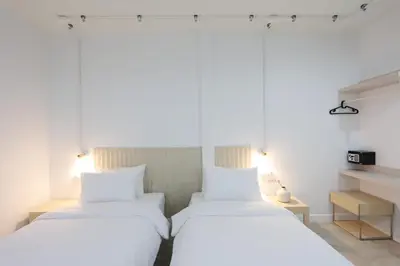 two beds sitting next to each other in a room at Lfour phuket in Phuket Town