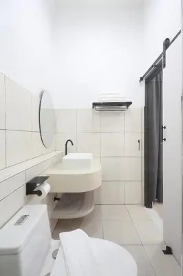 a white bathroom with a sink and a toilet at Lfour phuket in Phuket Town