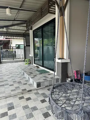 a porch with a swing in front of a building at Дом 2 спальни, 1 санузел in Ban Bang La