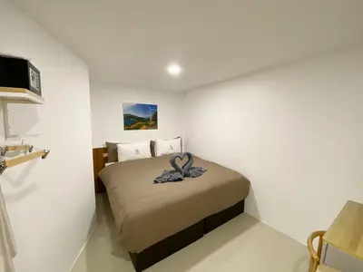 a bedroom with a bed with a flower on it at SJ Beach House Patong in Patong Beach