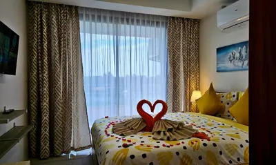 a bedroom with a bed with a heart on it at Уютная квартира рядом с пляжем Май Као in Ban Mai Salae