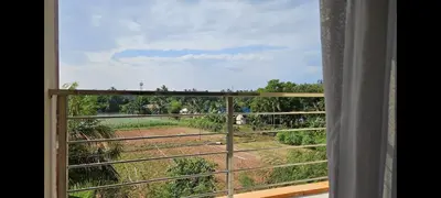 a window with a view of a field at Уютная квартира рядом с пляжем Май Као in Ban Mai Salae