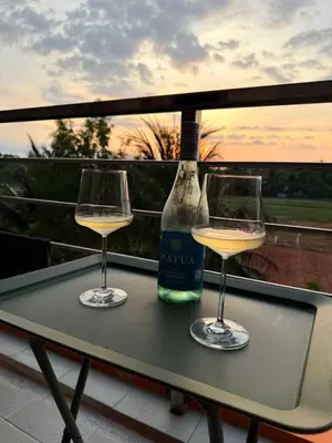 two glasses of white wine sitting on a table at Уютная квартира рядом с пляжем Май Као in Ban Mai Salae