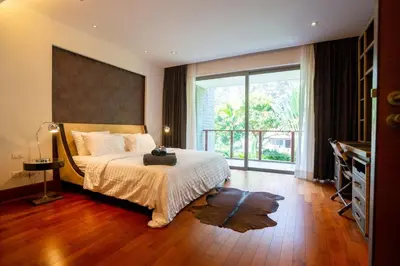 a bedroom with a bed and a large window at Suite of Naithon beachfront apartment in Nai Thon Beach