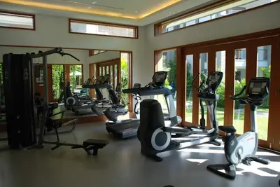 a gym with a bunch of exercise equipment in a room at Suite of Naithon beachfront apartment in Nai Thon Beach