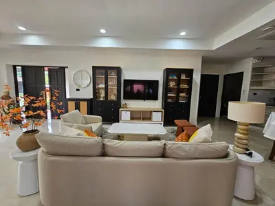 a living room with a couch and a table at Eden Villas Kamala in Kamala Beach