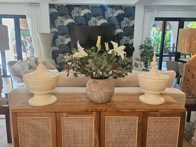 a living room with three vases on top of a table at Eden Villas Kamala in Kamala Beach