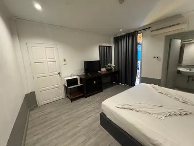 a hotel room with a bed and a television at At bedroom in Patong Beach