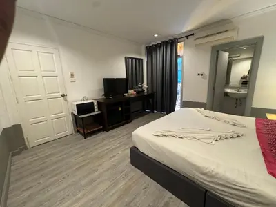 a bedroom with a bed and a television in it at At bedroom in Patong Beach